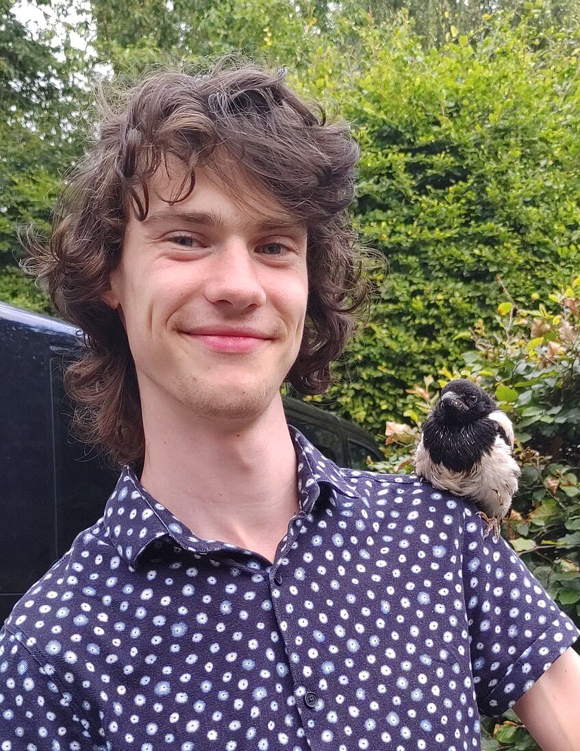 young man, bird sitting on shoulder