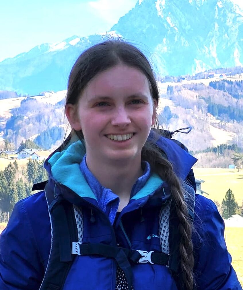 young woman in front of a mountain scenery