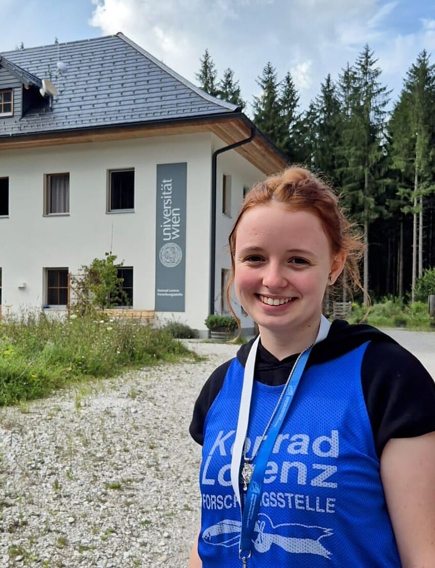 young woman in front of a research building